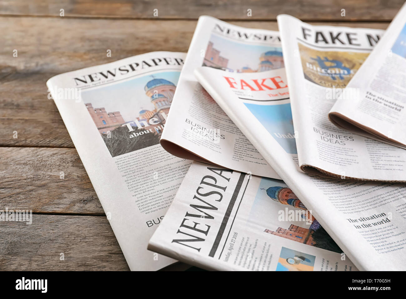 Newspapers on wooden background Stock Photo
