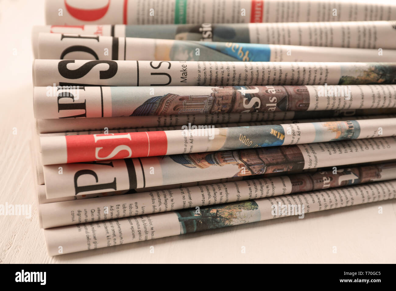Newspapers on white wooden background Stock Photo