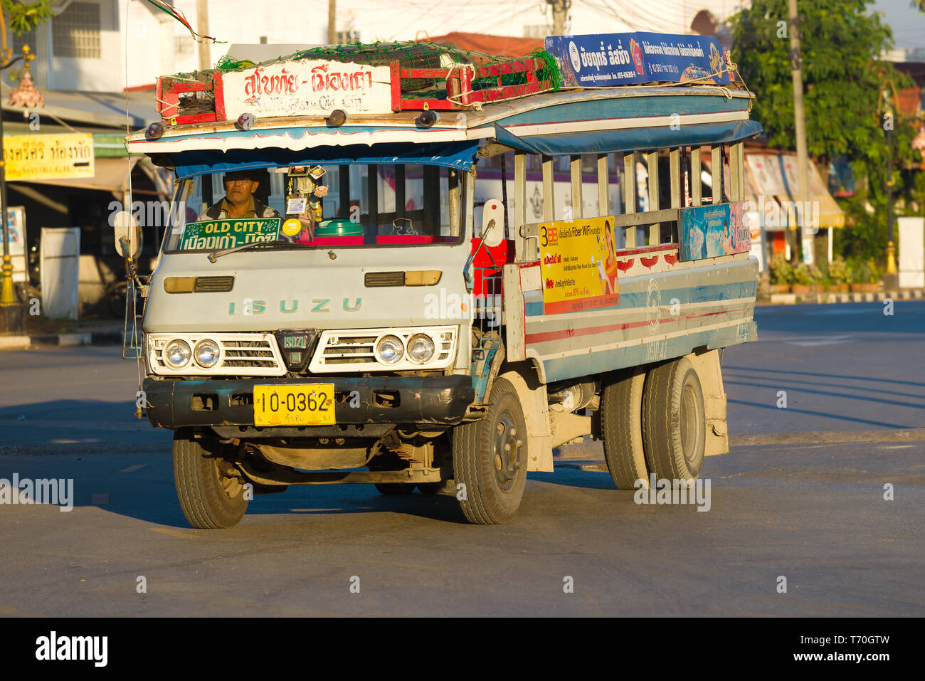 SUKHOTHAI, THAILAND - DECEMBER 26, 2018: The city bus on the basis of the old Isuzu truck a close up in the solar early morning Stock Photo