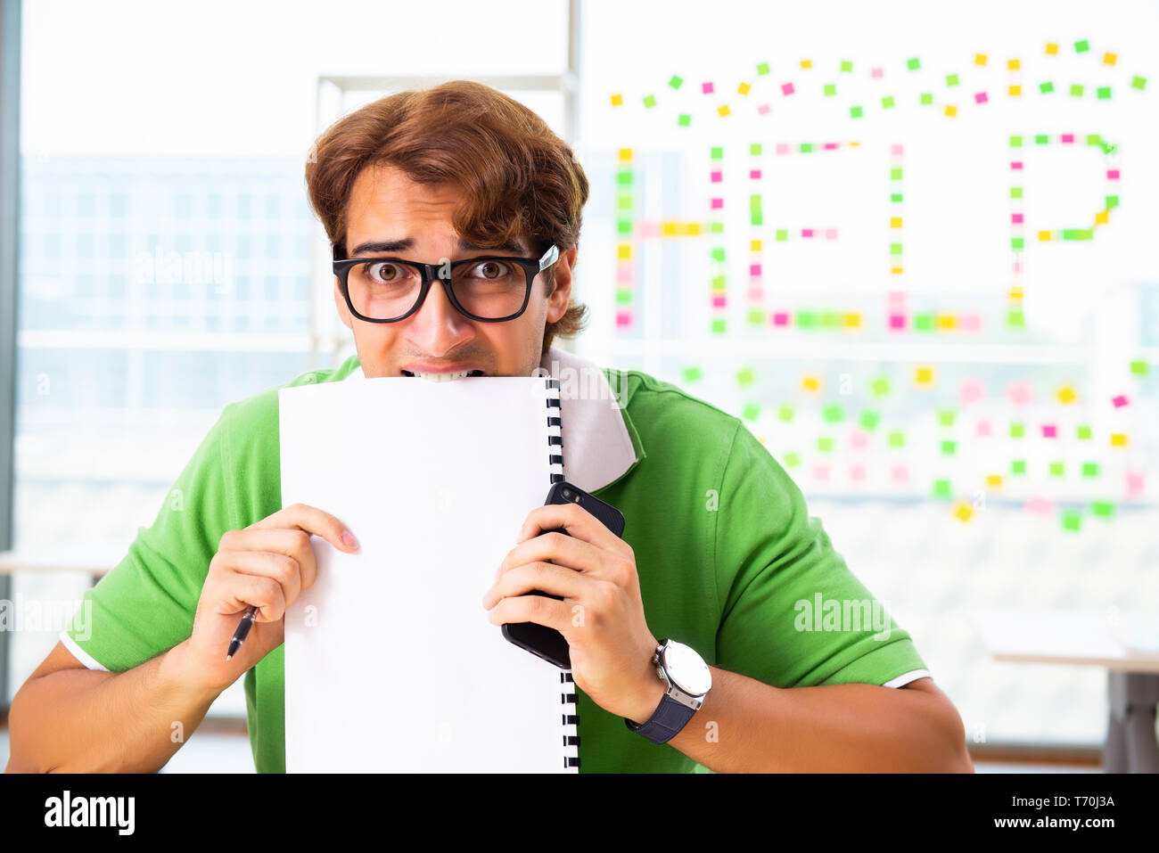 Student struggling at the exam in classroom Stock Photo