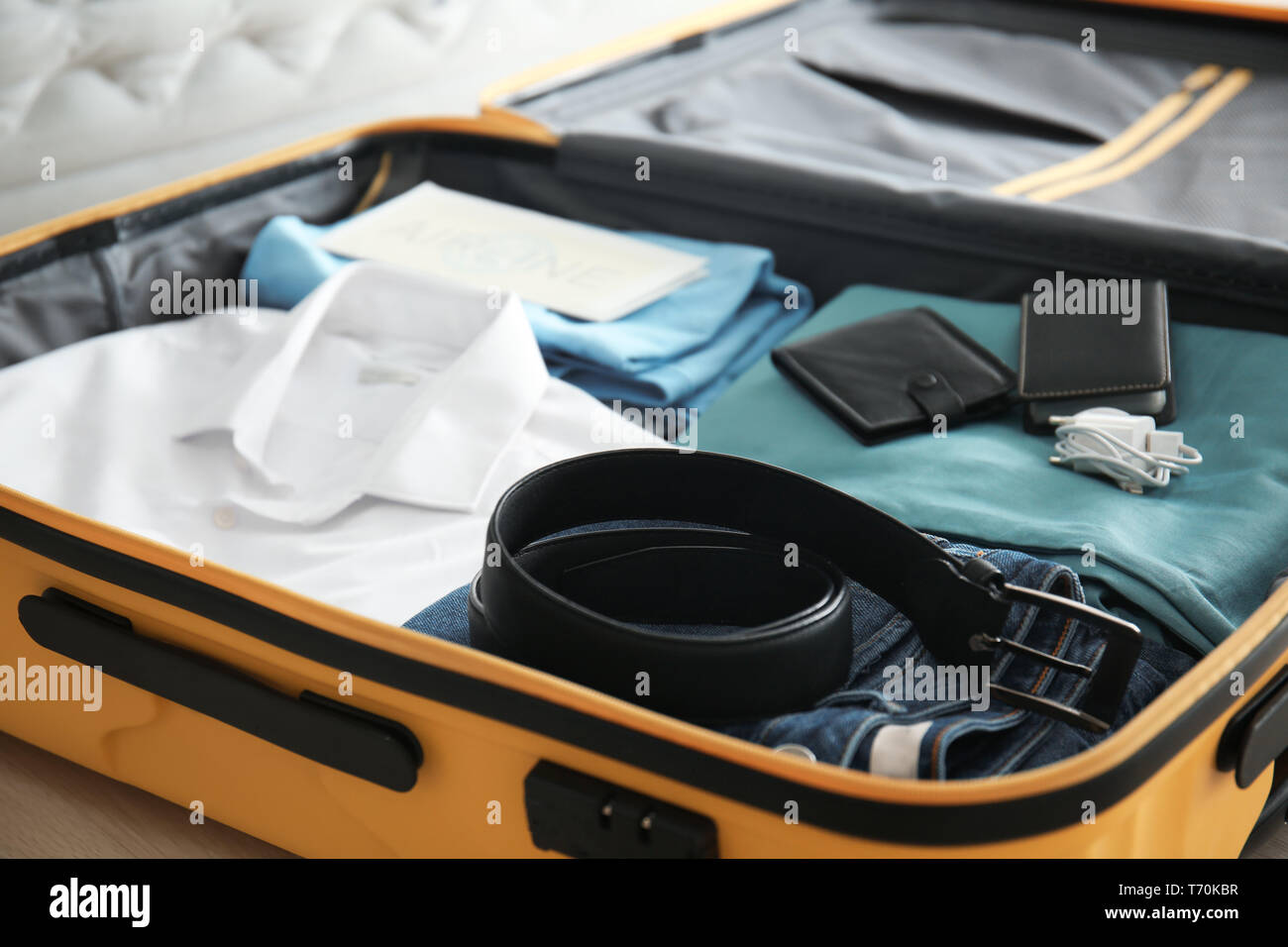 Open suitcase with packed things, closeup Stock Photo