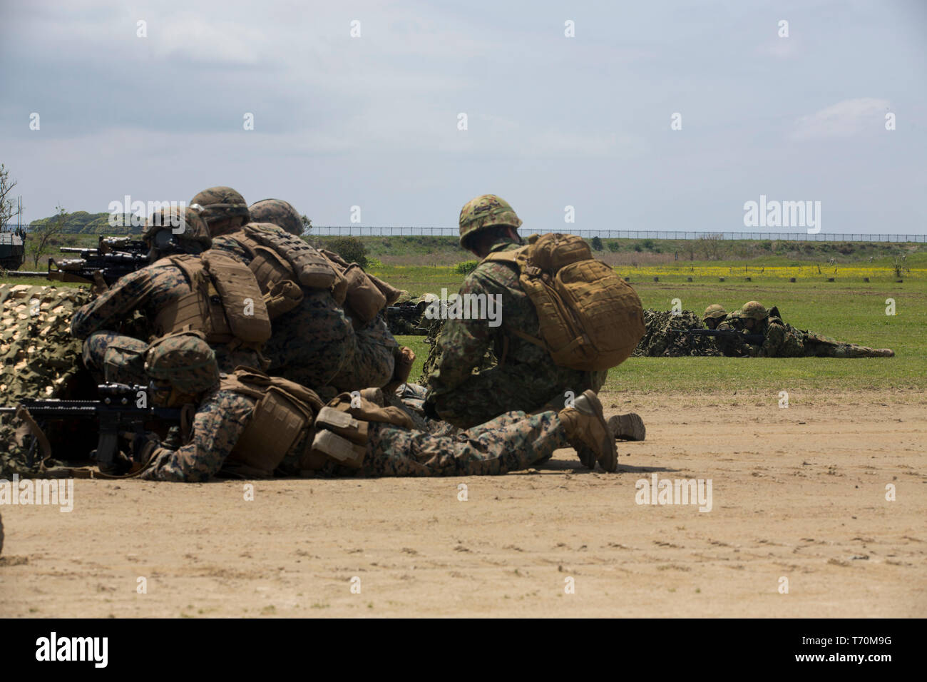 Soldiers of the Japan Ground Self-Defense Force’s Amphibious Rapid Deployment Brigade and U.S. Marines from Bravo Company, Battalion Landing Team, 1st Battalion, 4th Marines, conduct an assault demonstration during subject matter expert exchanges at Camp Ainoura, Sasebo, Japan, April 26, 2019. BLT 1/4 is the Ground Combat Element for the 31st Marine Expeditionary Unit. The weeklong SMEE reinforced the U.S. Marine-JGSDF partnership and commemorated the 1st anniversary of the ARDB. The 31st MEU, the Marine Corps’ only continually forward-deployed MEU, provides a flexible and lethal force ready t Stock Photo