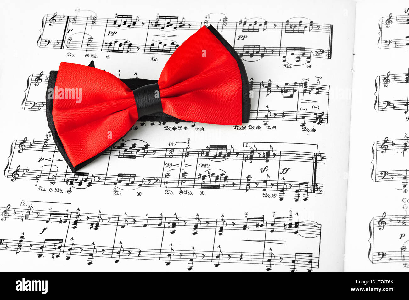 Red bow tie on music sheet Stock Photo