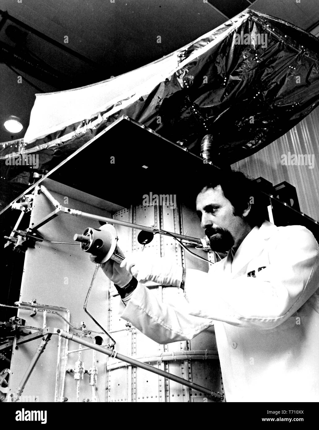 RCA engineer Joel Bacher adjusting a propulsion thruster on the RCA Satcom domestic communication satellite, December 10, 1975. Image courtesy National Aeronautics and Space Administration (NASA). () Stock Photo