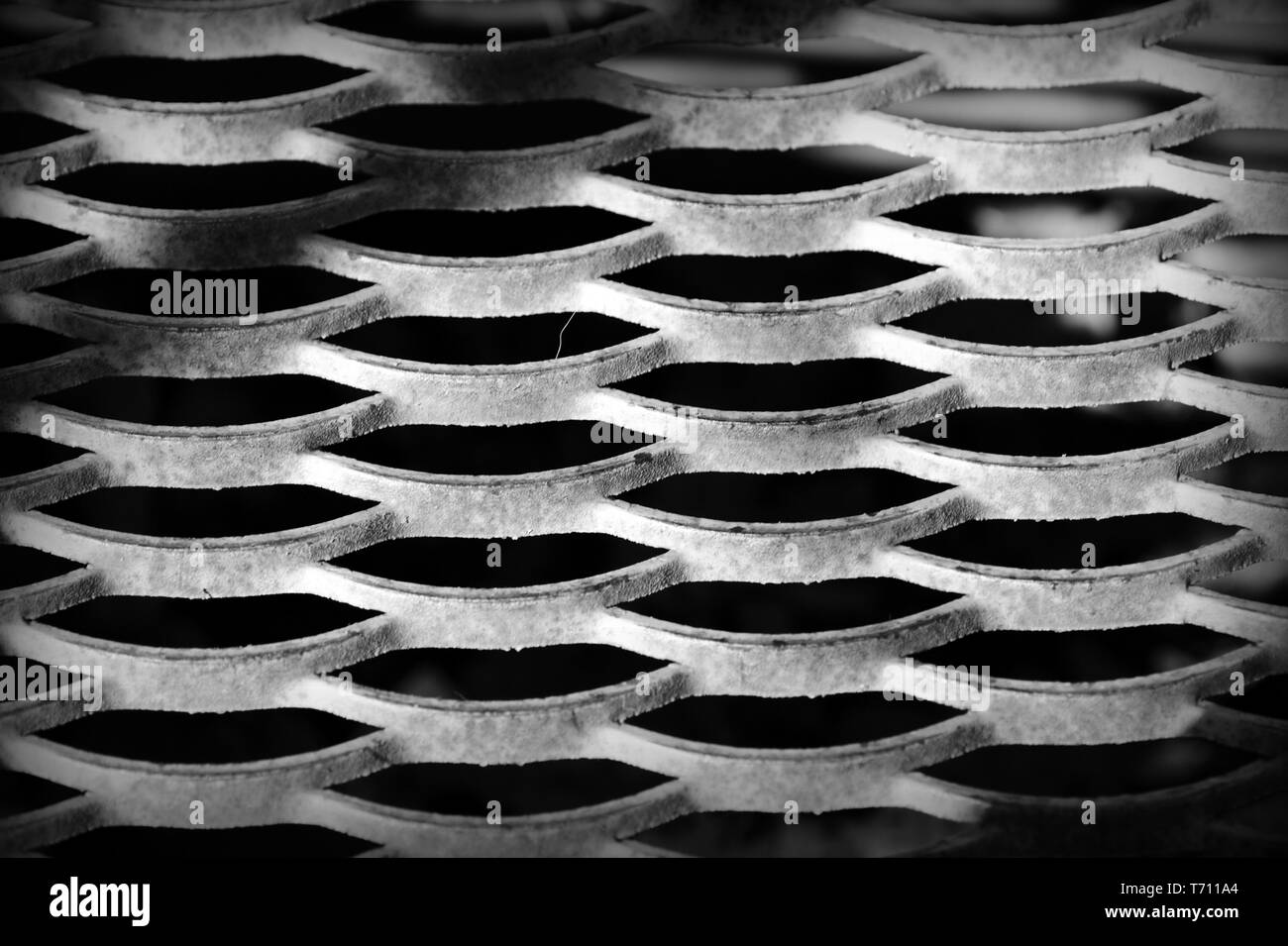 Old iron mesh close up. Abstract background black and white Stock Photo