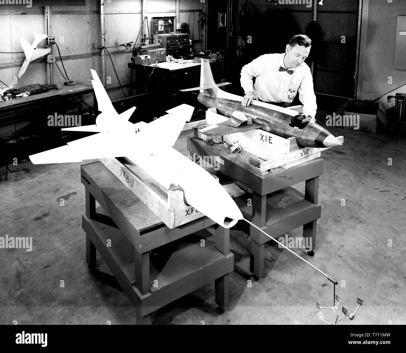 Photograph of the NASA technician preparing the Bell X-1E and the Vought XF-8U Crusader dynamic models for wind tunnel testing, February 19, 1957. Image courtesy National Aeronautics and Space Administration (NASA). () Stock Photo