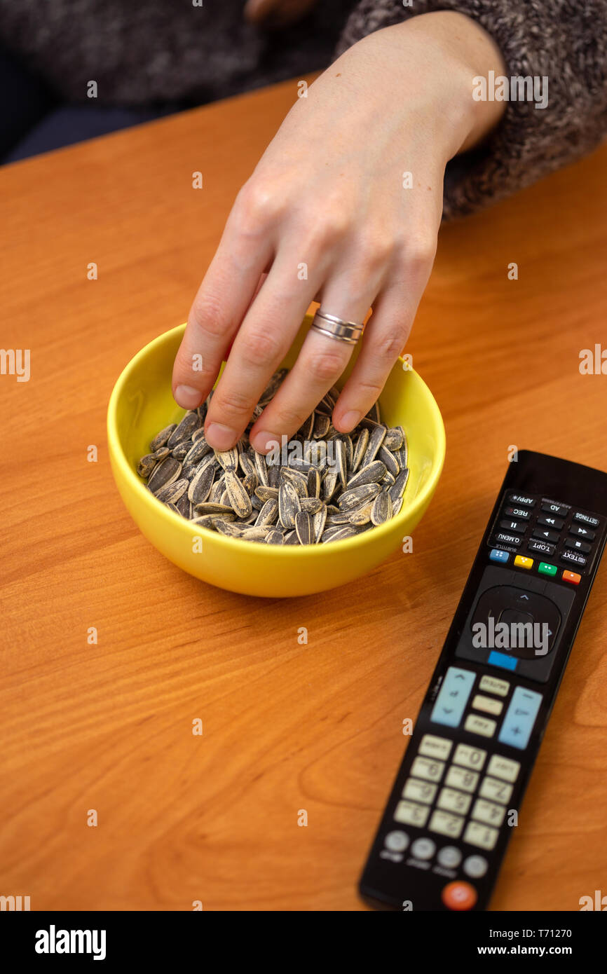 People eating roasted sunflower seed Stock Photo Alamy
