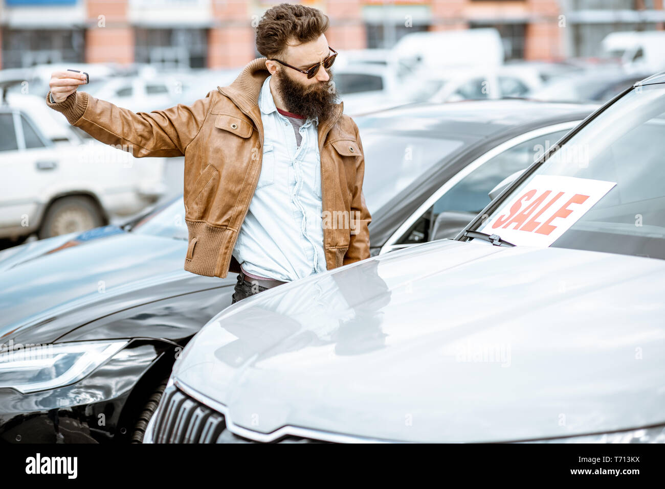 Man choosing luxury car to buy on the open ground of the dealership Stock Photo