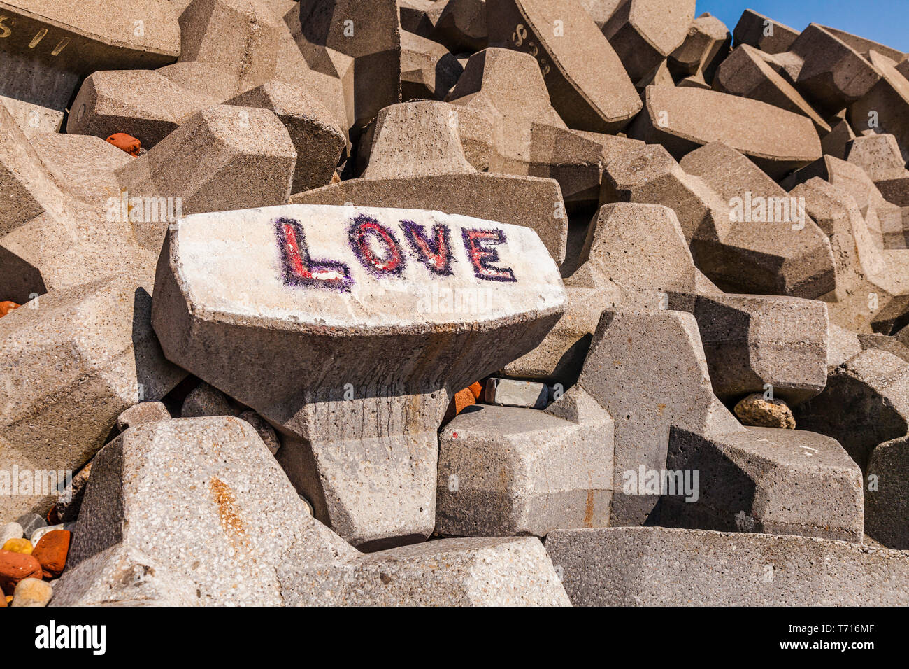 A concept of 'Love on the Rocks' at Hartlepool,England,UK with the word 'Love' daubed in graffitti on the rocks on the beach Stock Photo