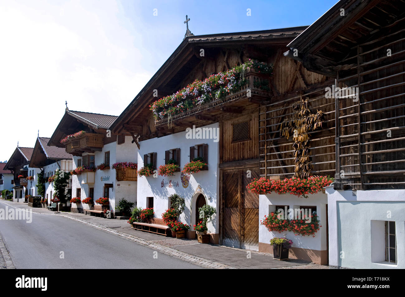 Mutters, Tyrol/ Austria: The main road  lined with traditional tirolian houses heavily decorated with geraniums Stock Photo