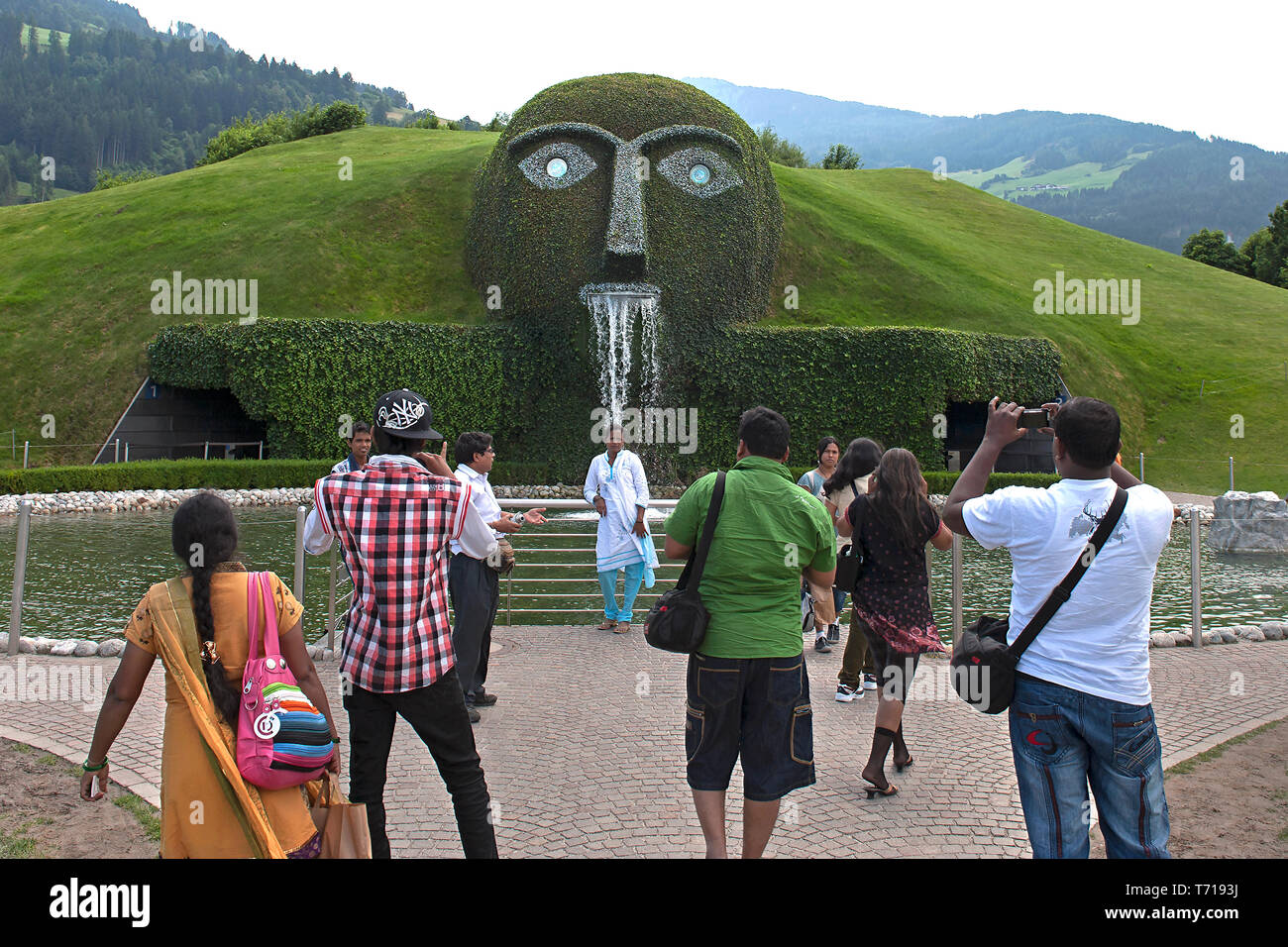 Wattens, Tyrol/ Austria: Tourists looking at the Giant, a fountain by Austrian artist André Heller, located at the Crystal Worlds Stock Photo