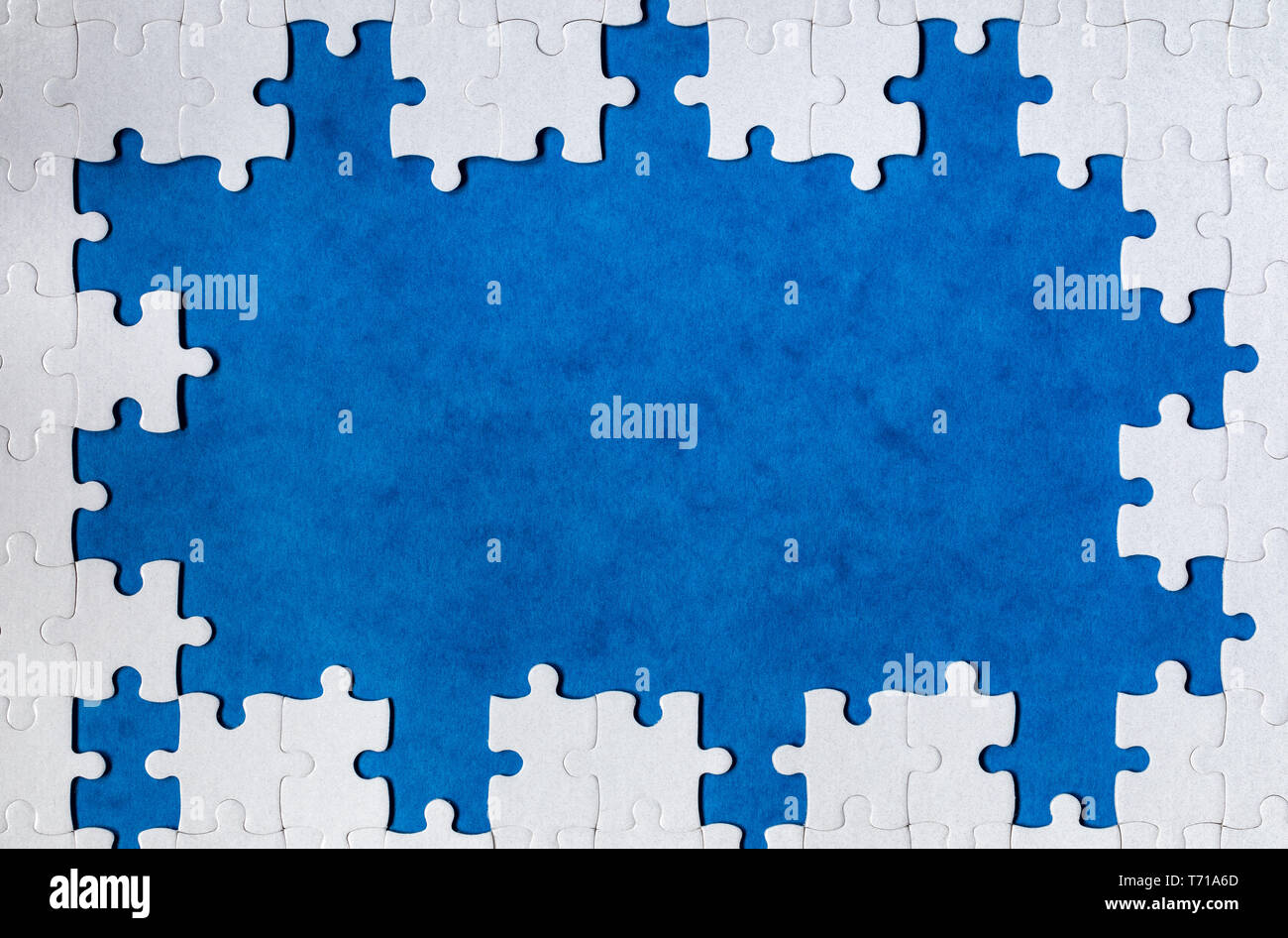 Framing in the form of a rectangle, made of a white jigsaw puzzle