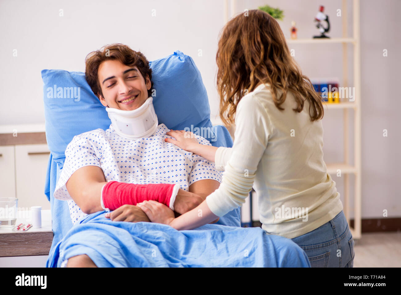 Loving Wife Looking After Injured Husband In Hospital Stock Photo Alamy