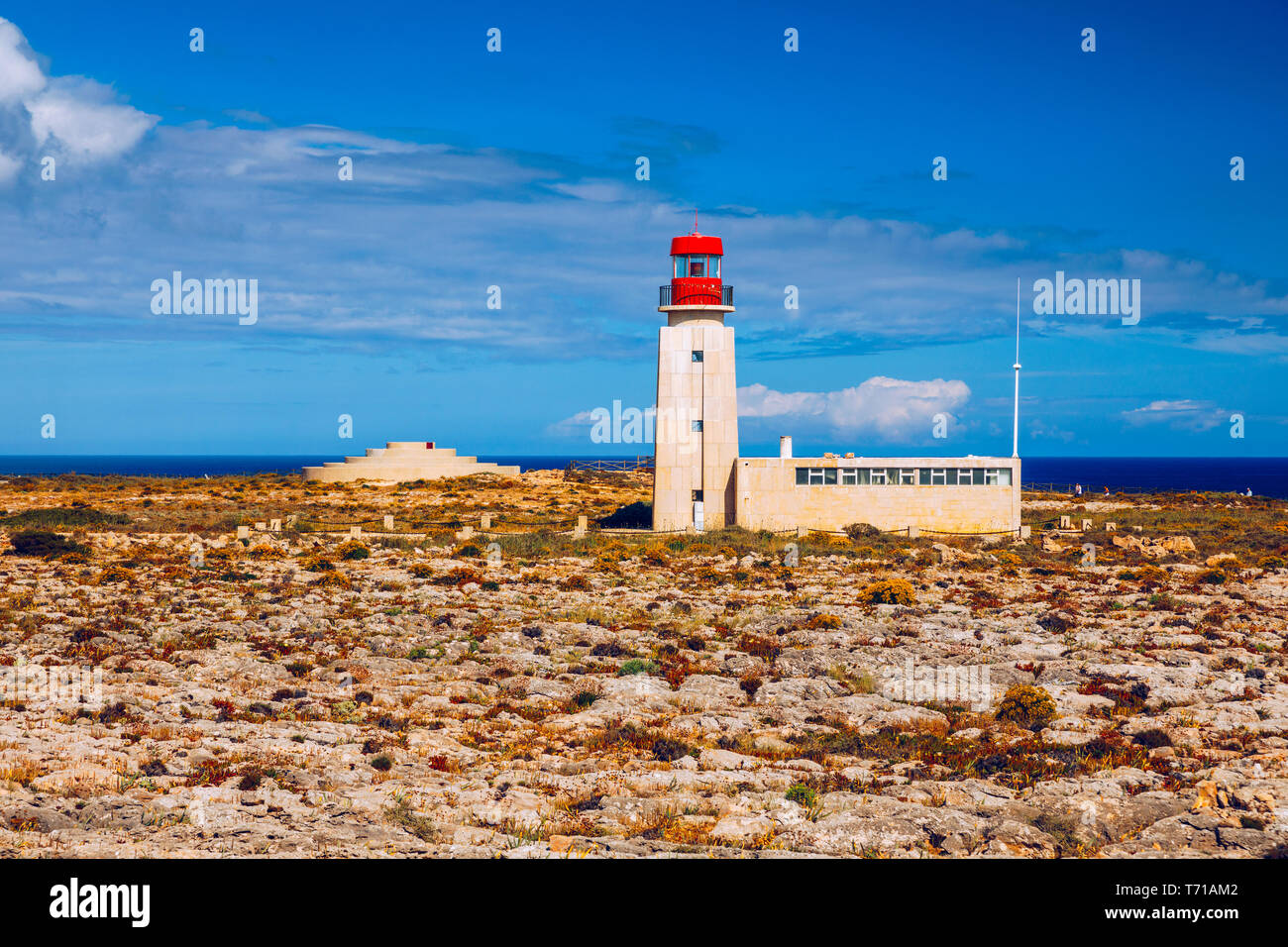 Lighthouse in Fortaleza de Sagres, Portugal, Europe on a cliff. This beautiful ancient architecture is used for navigation by ships and boats. Great d Stock Photo