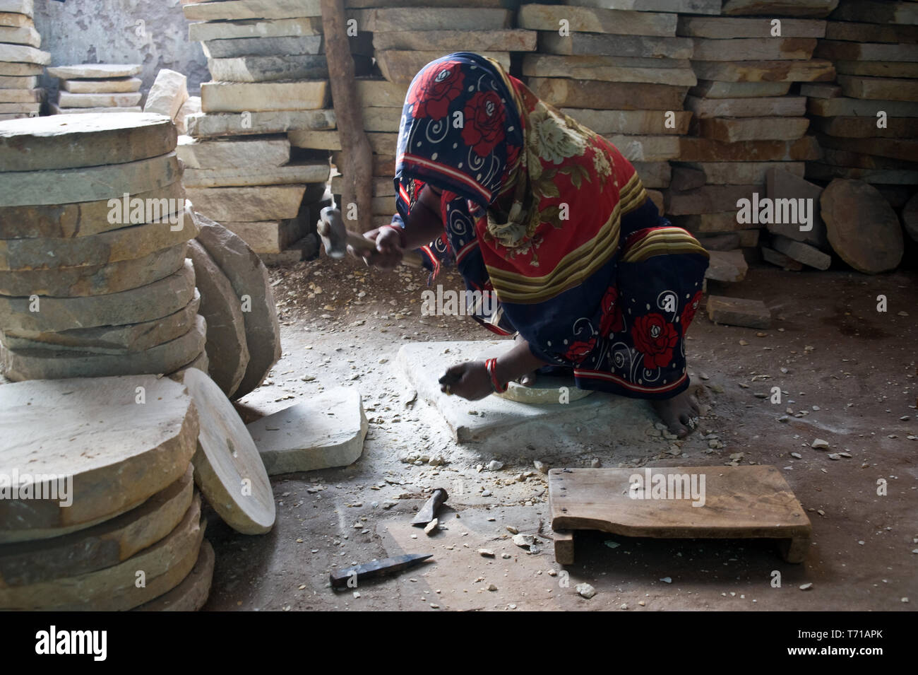 Female worker making a grinder ( India) Stock Photo