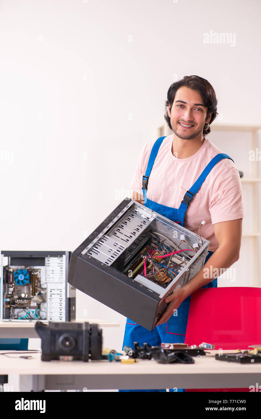 Young male contractor repairing computer Stock Photo