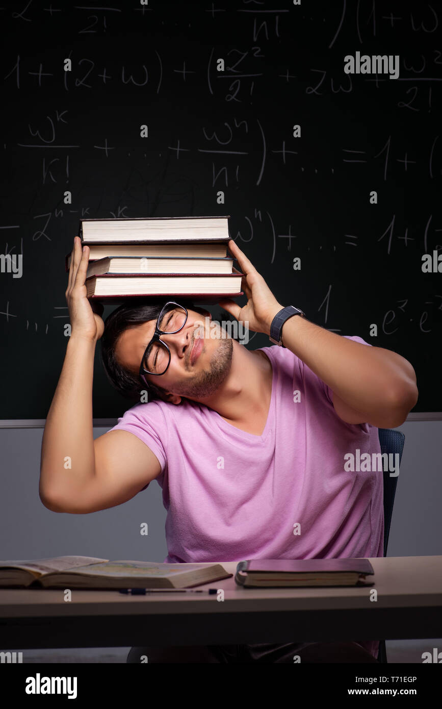 Young male student sitting in classroom Stock Photo - Alamy