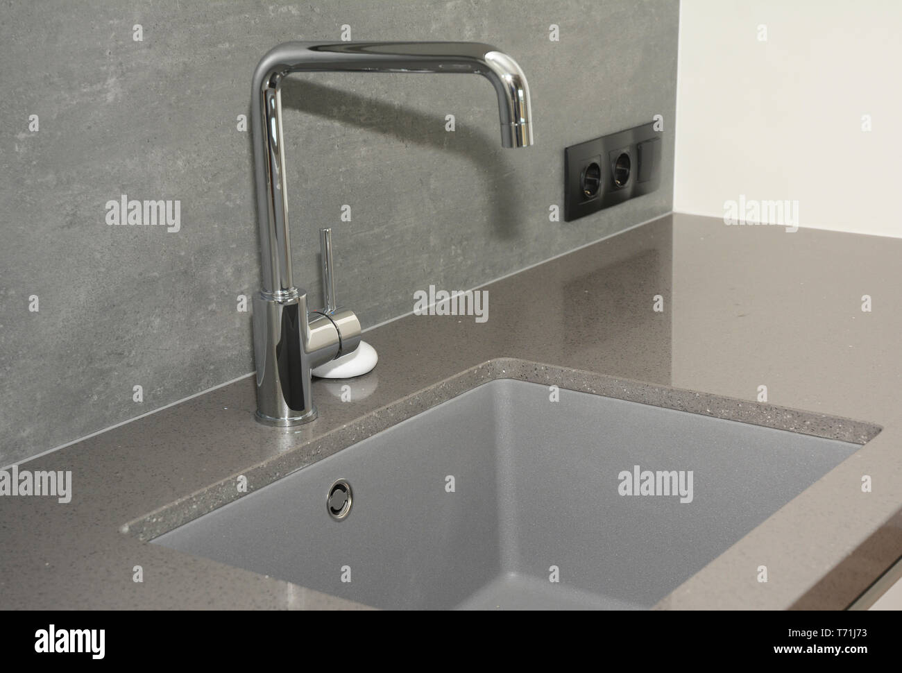 Ceramic kitchen sink. Modern kitchen metal faucet and ceramic kitchen