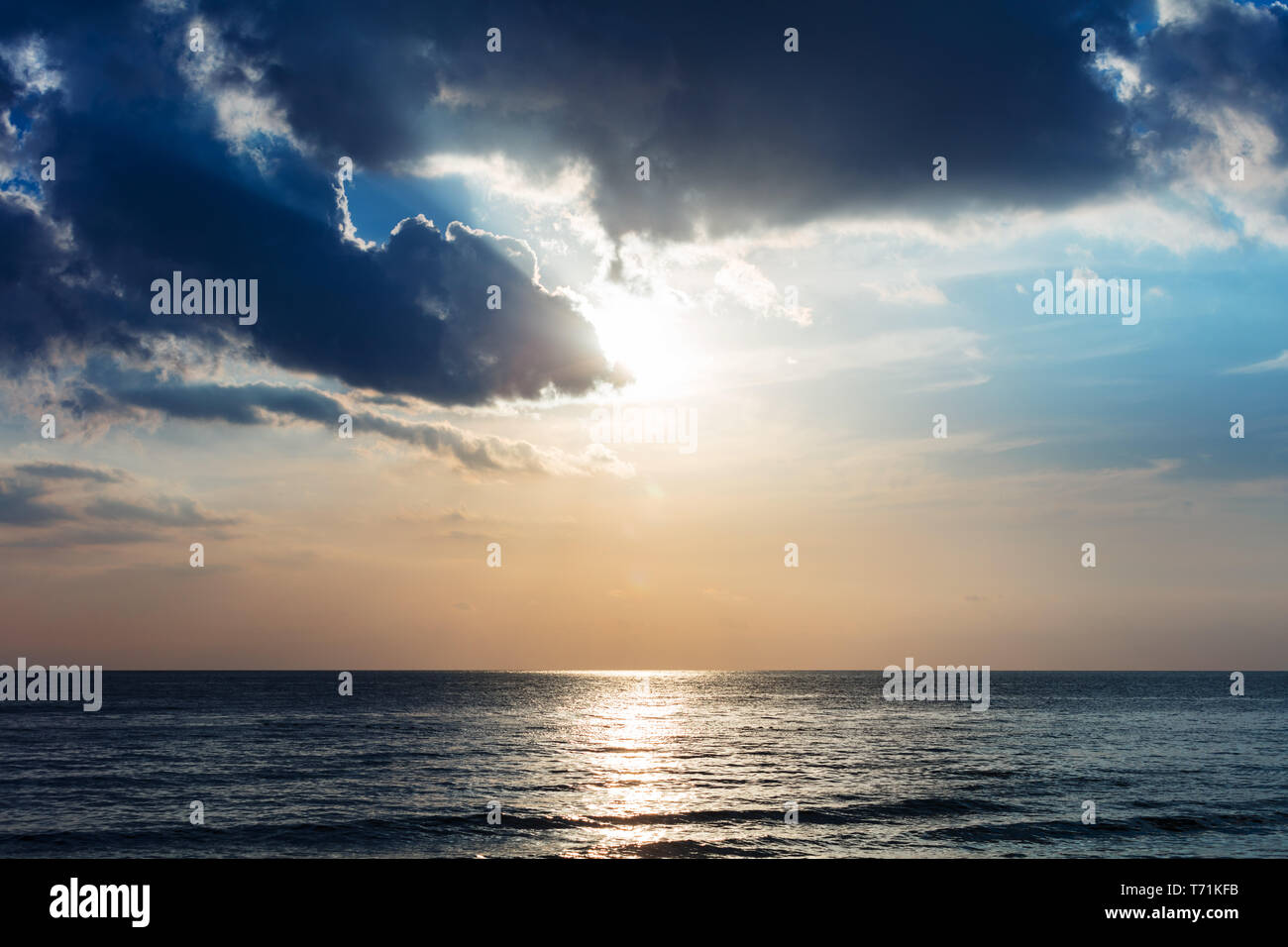 sunset over ocean and clouds Stock Photo