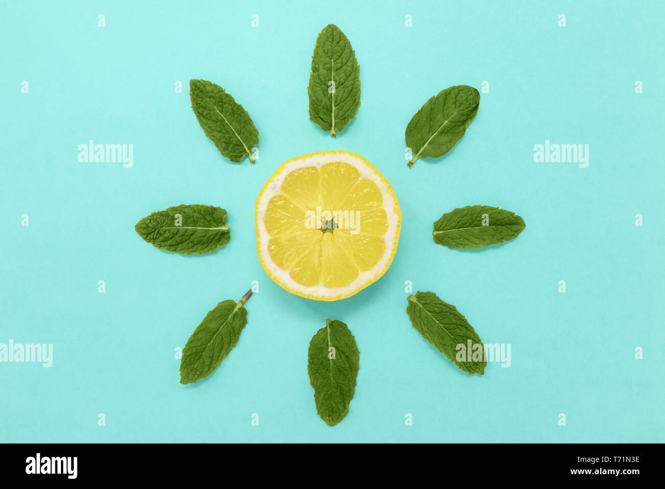 Lemon slice with mint. Minimal summer sun concept, flat lay. Stock Photo