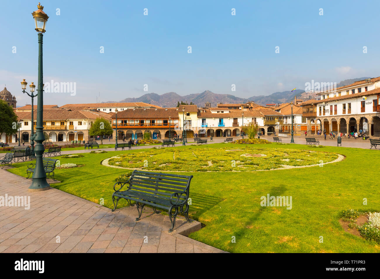 Parade Ground garden and historic buildings of Cuzco at sunse Stock Photo