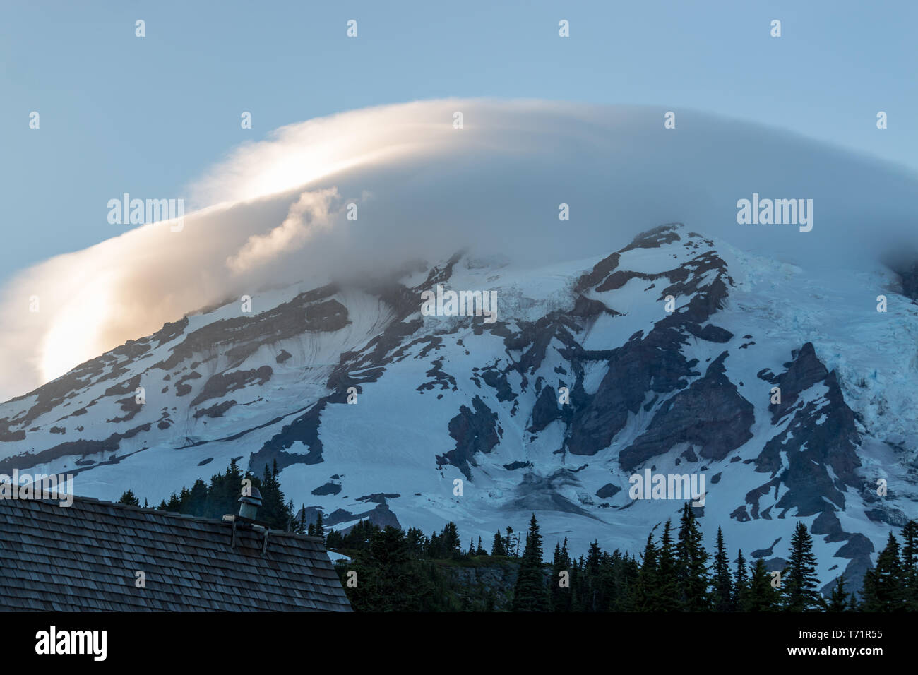 Lenticular clouds cover the top of Mt Rainier in Washington state on a ...