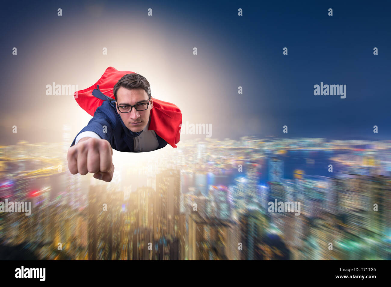 Superhero businessman flying over the city Stock Photo