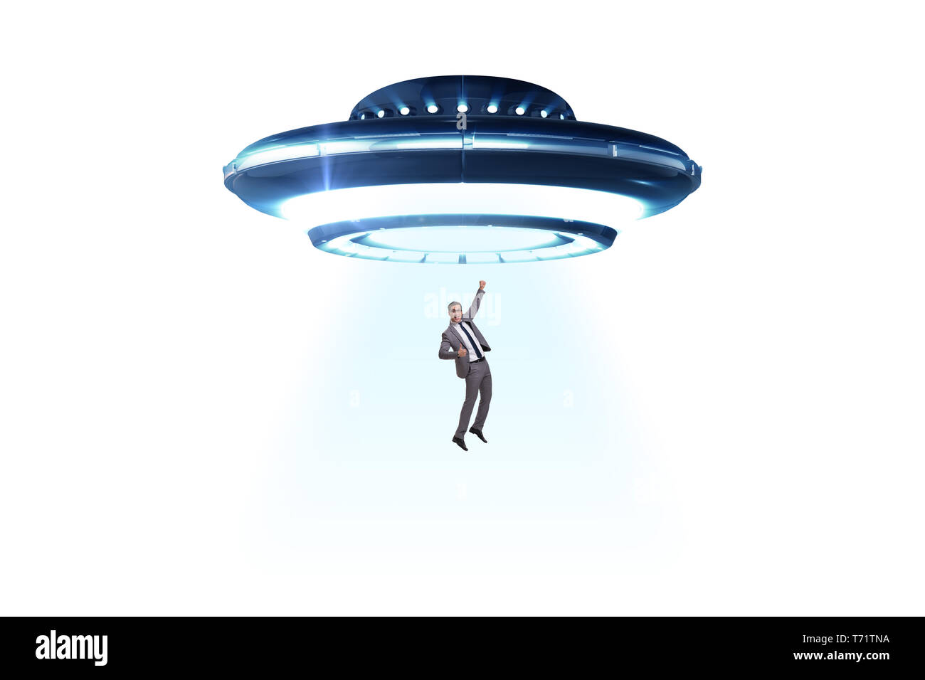 Flying saucer abducting young businessman Stock Photo Alamy