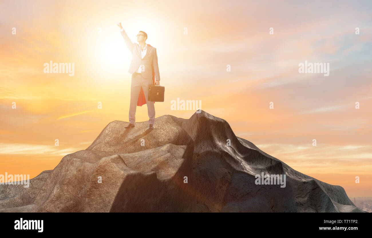Superhero businessman on top of mountain Stock Photo - Alamy