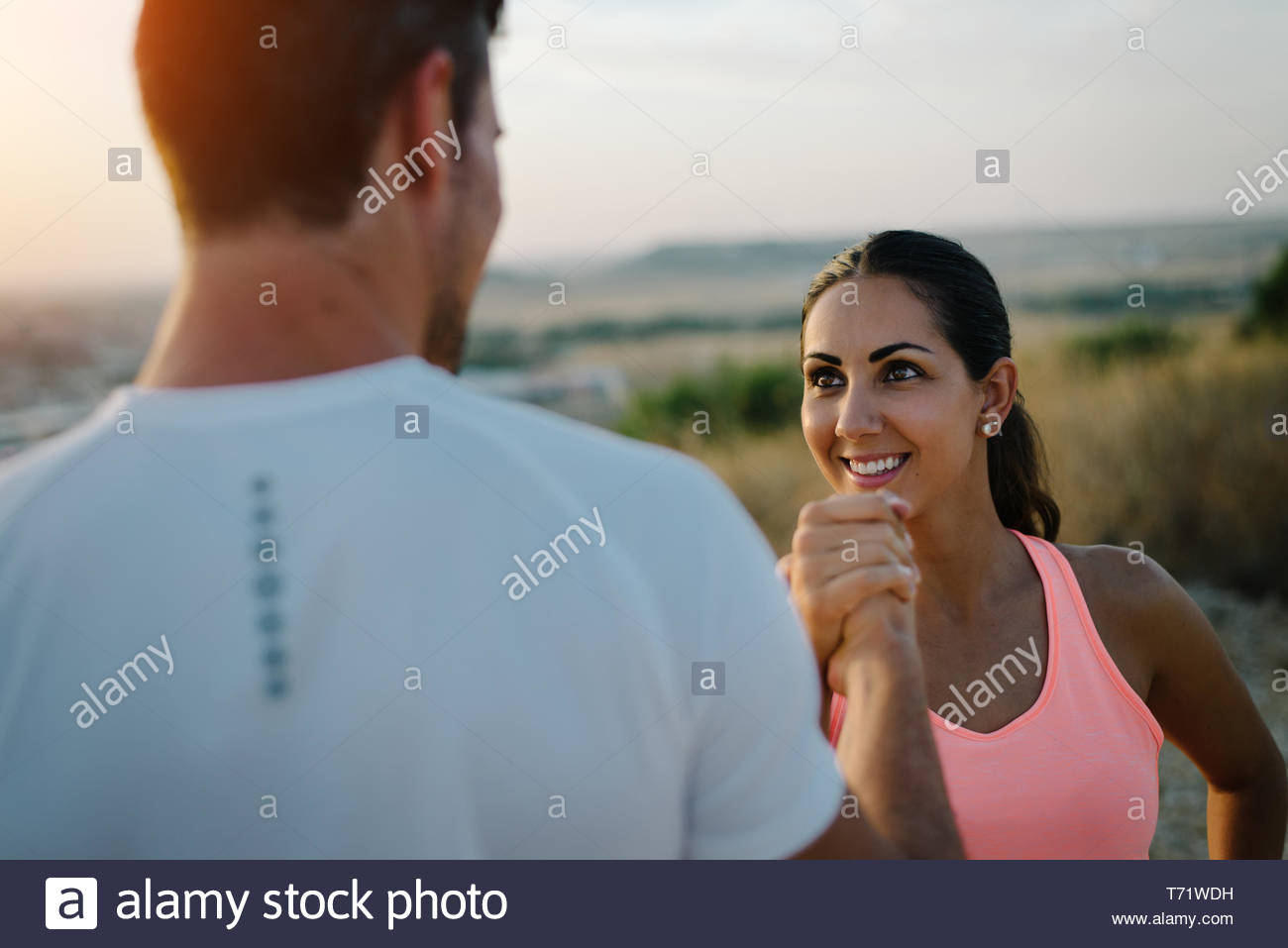 Couple Of Athletes Giving High Five For Celebrating Outdoor