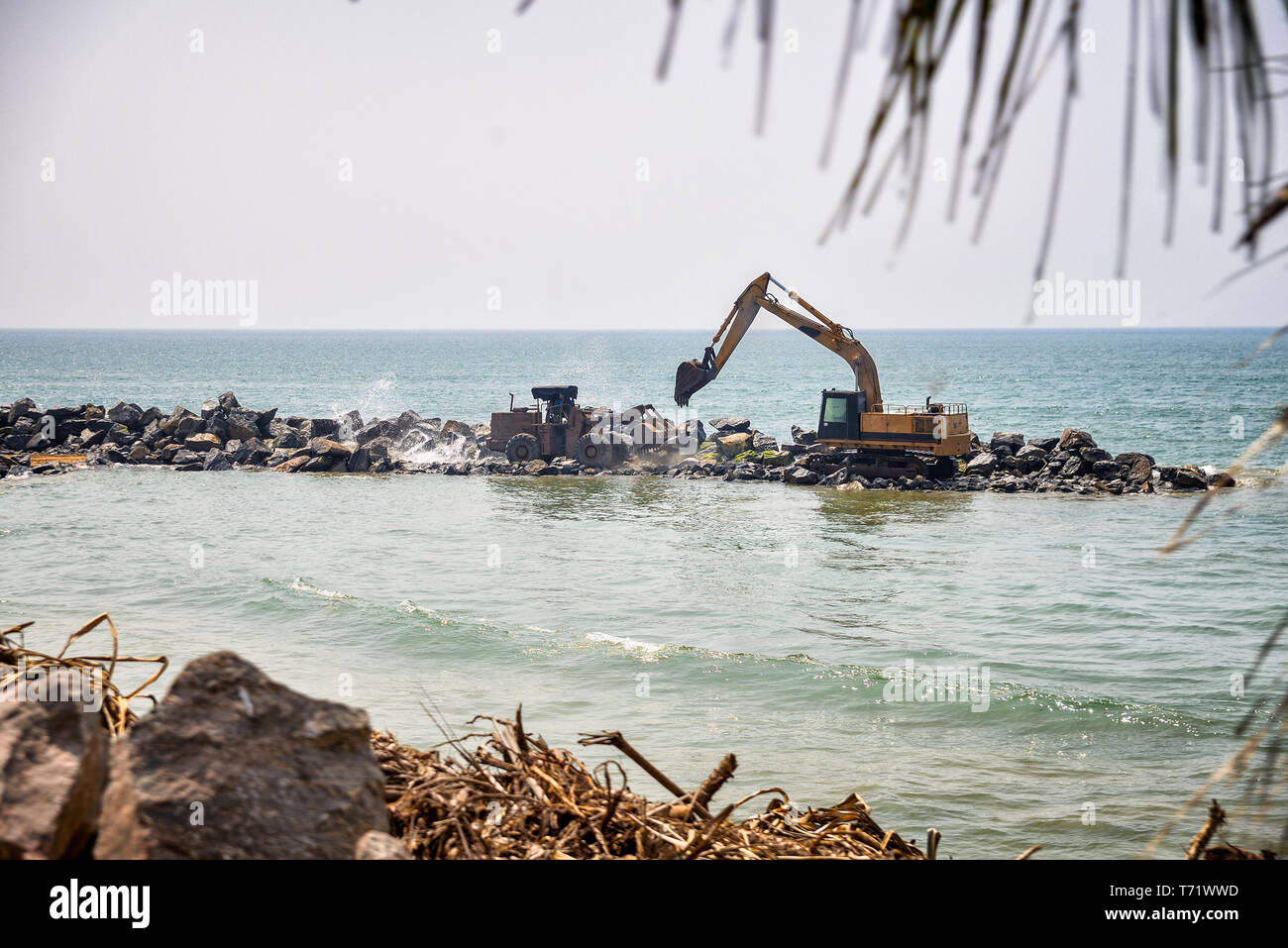 tractor and excavator near the ocean Stock Photo