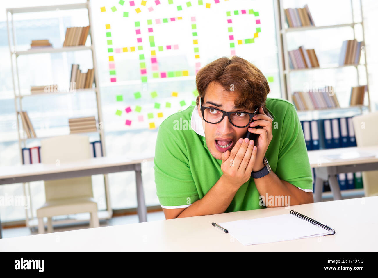 Student struggling at the exam in classroom Stock Photo