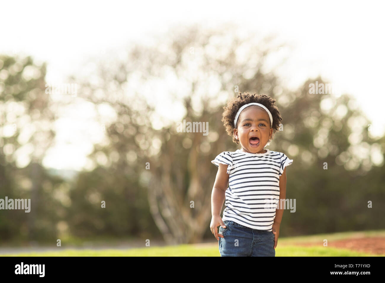 Happy African American little girl laughing and smiling outside Stock ...