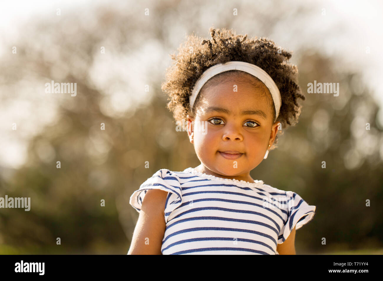 Happy African American little girl laughing and smiling outside Stock ...