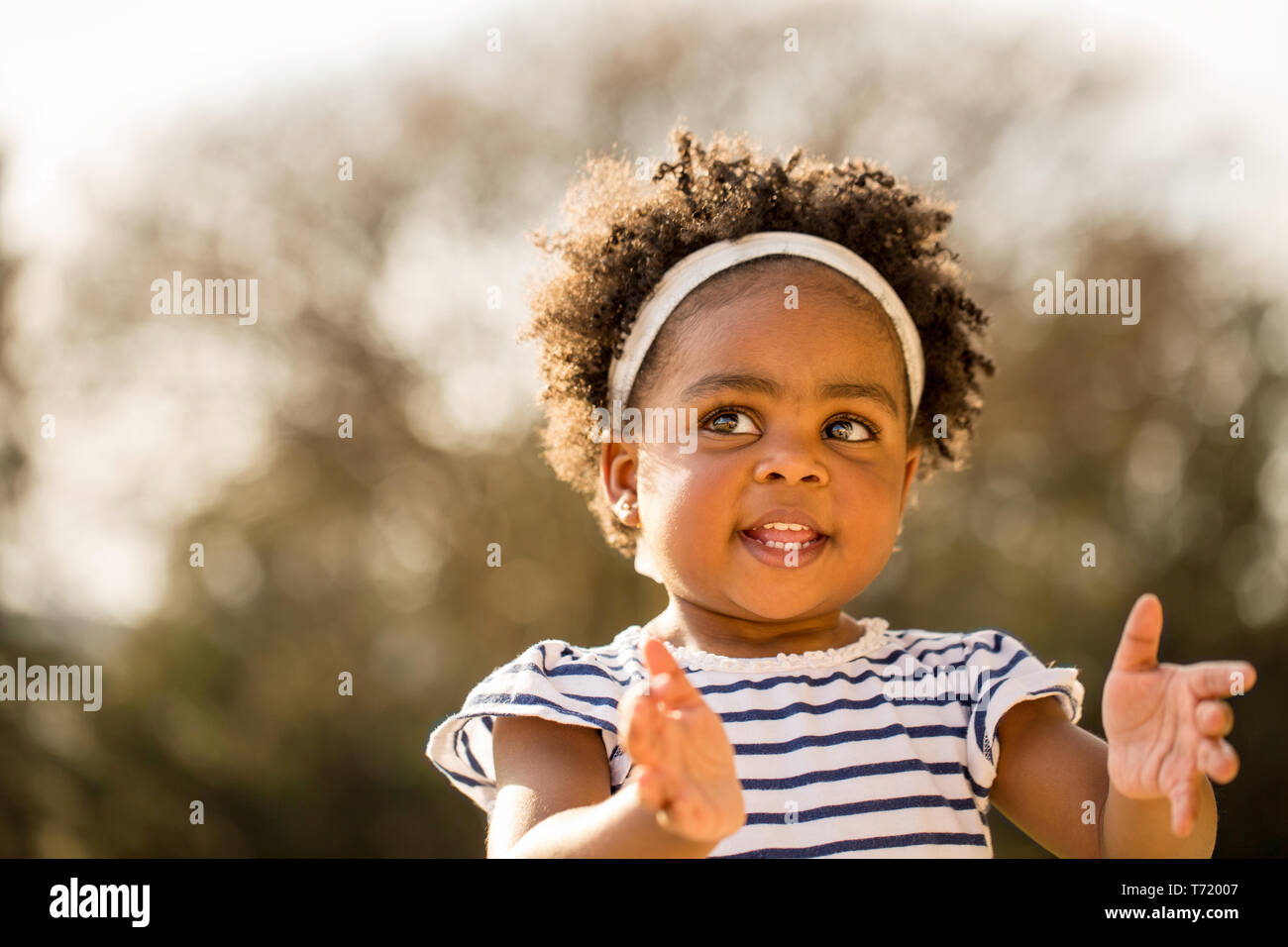 Happy African American little girl laughing and smiling outside Stock ...