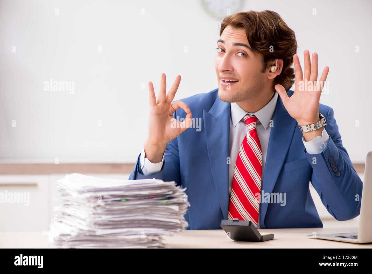Deaf employee using hearing aid in office Stock Photo Alamy