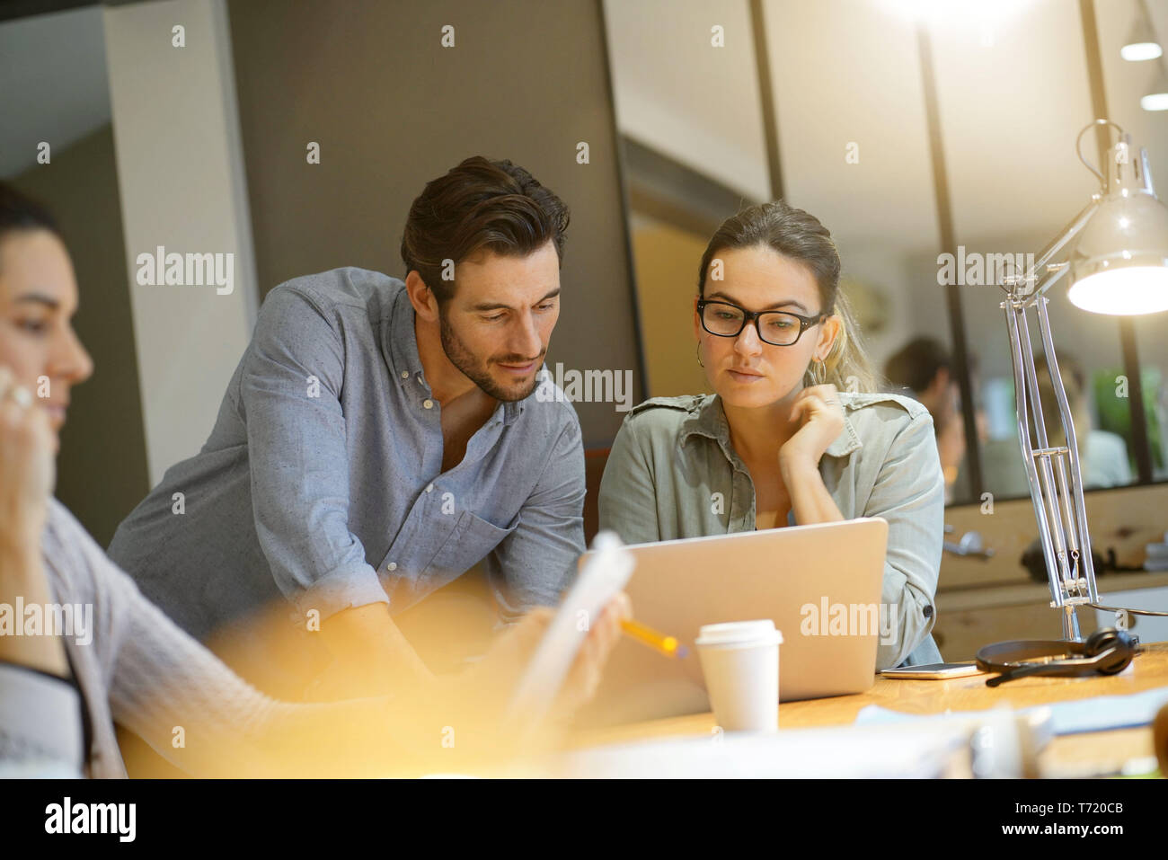 Colleagues looking over ideas in co working space Stock Photo - Alamy