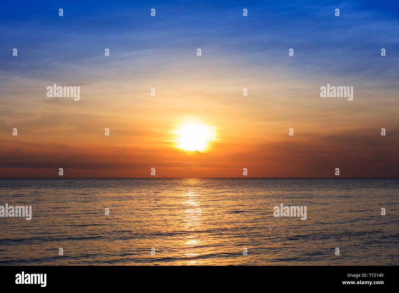 sunset over ocean on a clear day Stock Photo