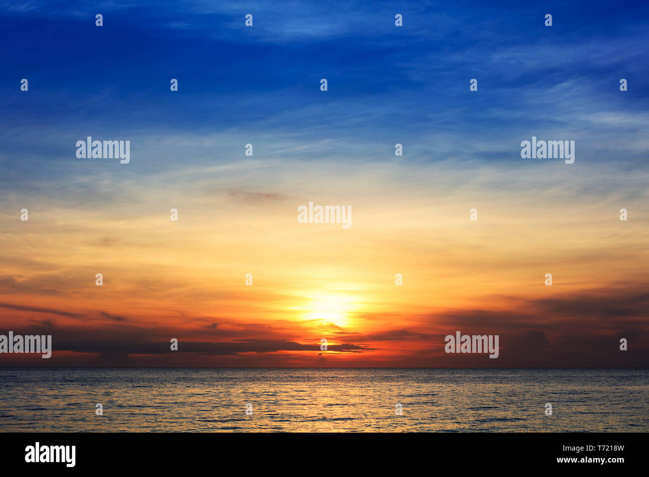 sunset over the ocean on clear day Stock Photo