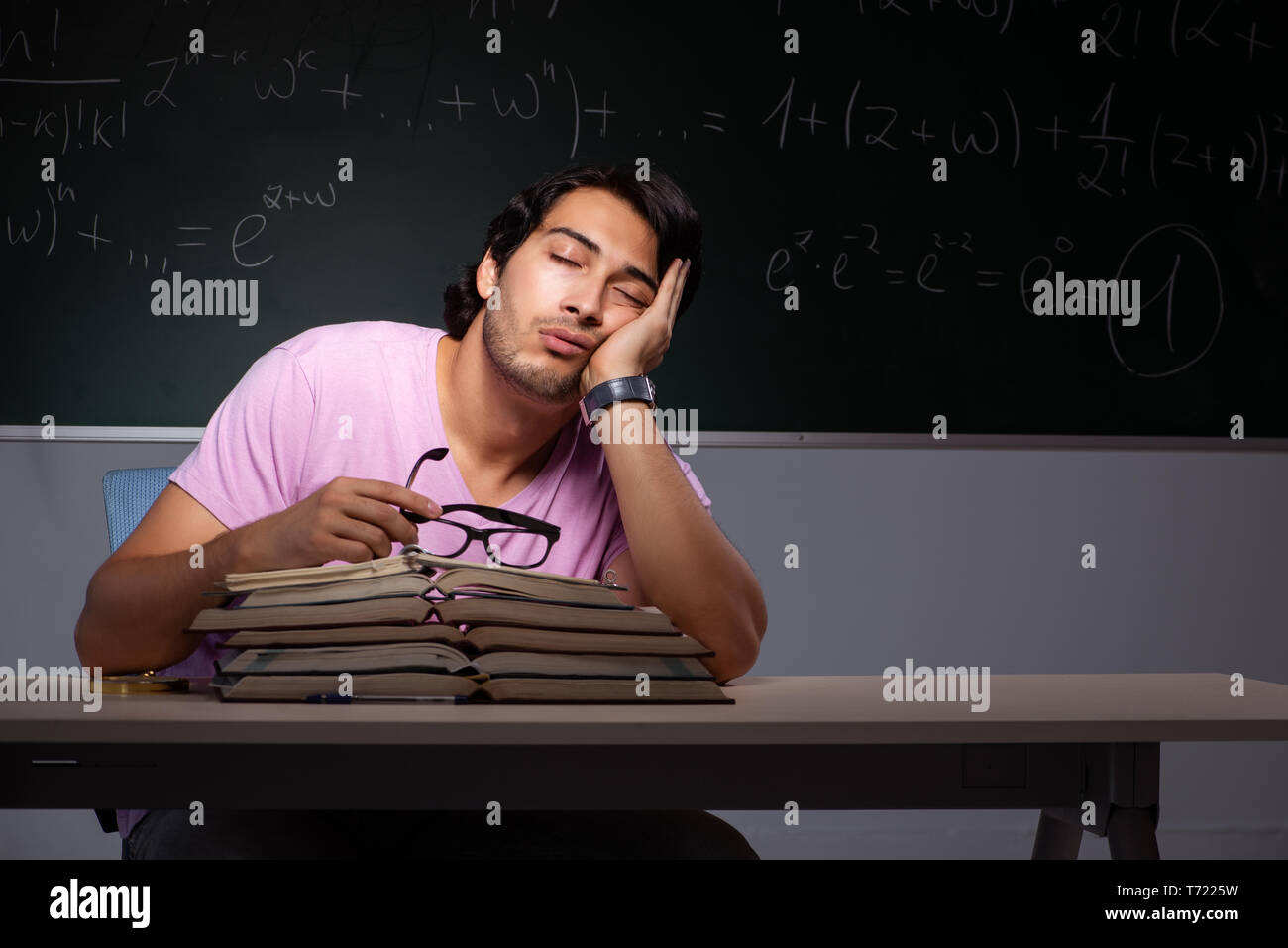 Young male student sitting in classroom Stock Photo - Alamy