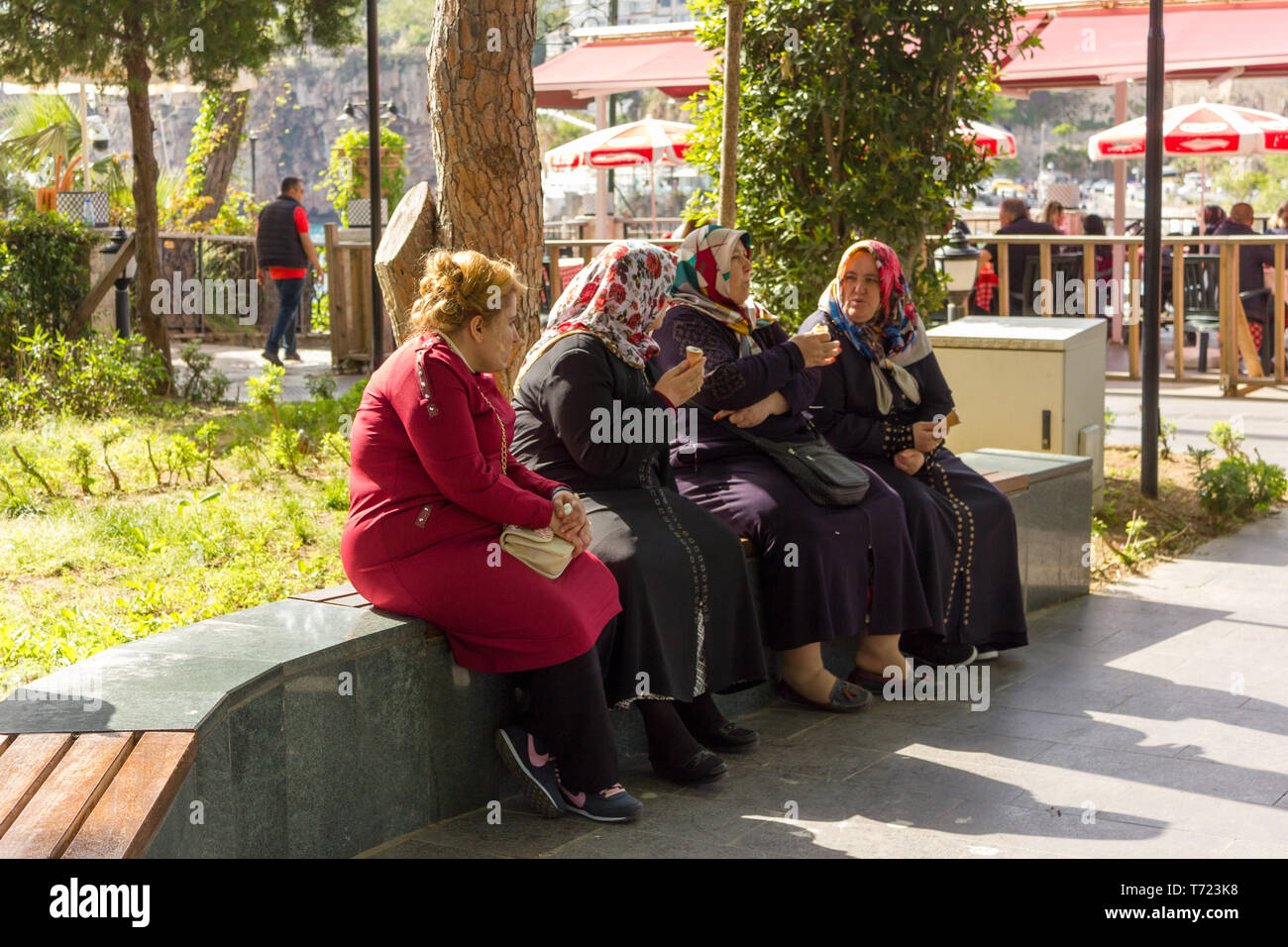 Turkish cheerful old ladies talking and eating ice cream in old town - Antalya, Turkey, 04.23.2019 Stock Photo