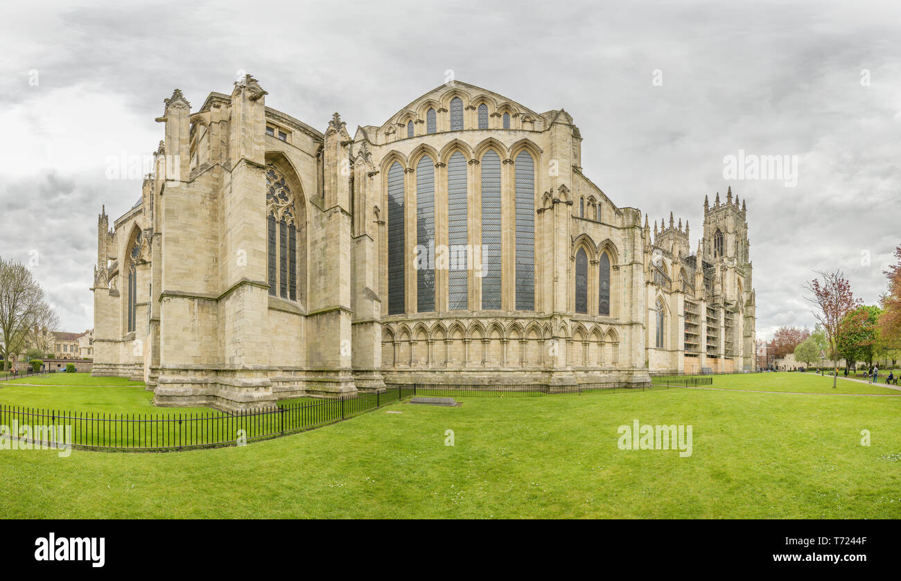 Dean's park and the north transept window of the medieval cathedral (minster) at York, England, on an overcast spring day. Stock Photo