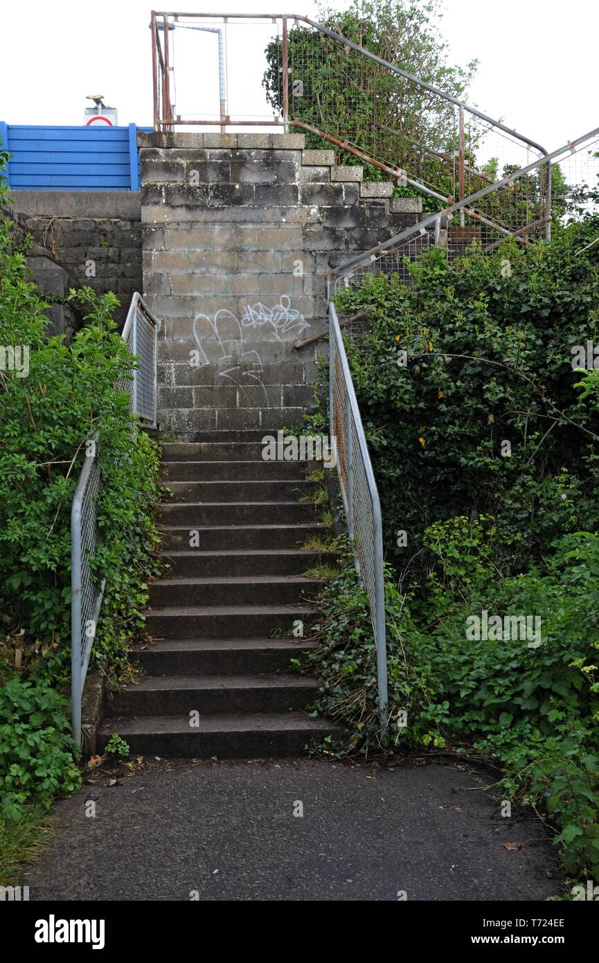 neglected and overgrown steps with graffiti at Barry Island, South Wales Stock Photo
