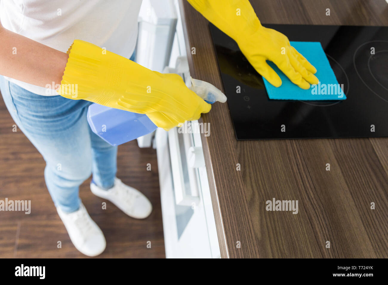 A Young Woman From A Professional Cleaning Company Cleans Up At