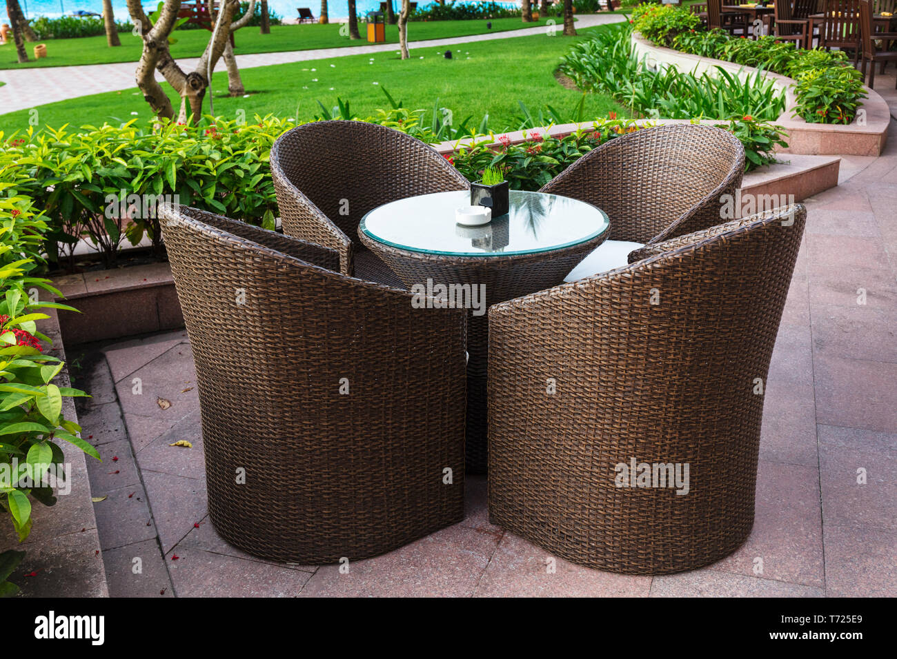 table and chairs in empty cafe next to pool Stock Photo