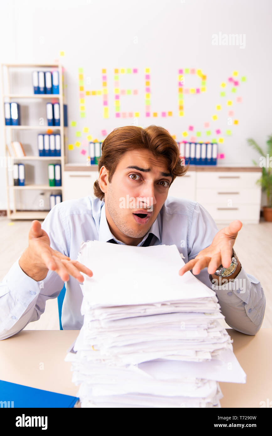 Young employee suffering from excessive work Stock Photo