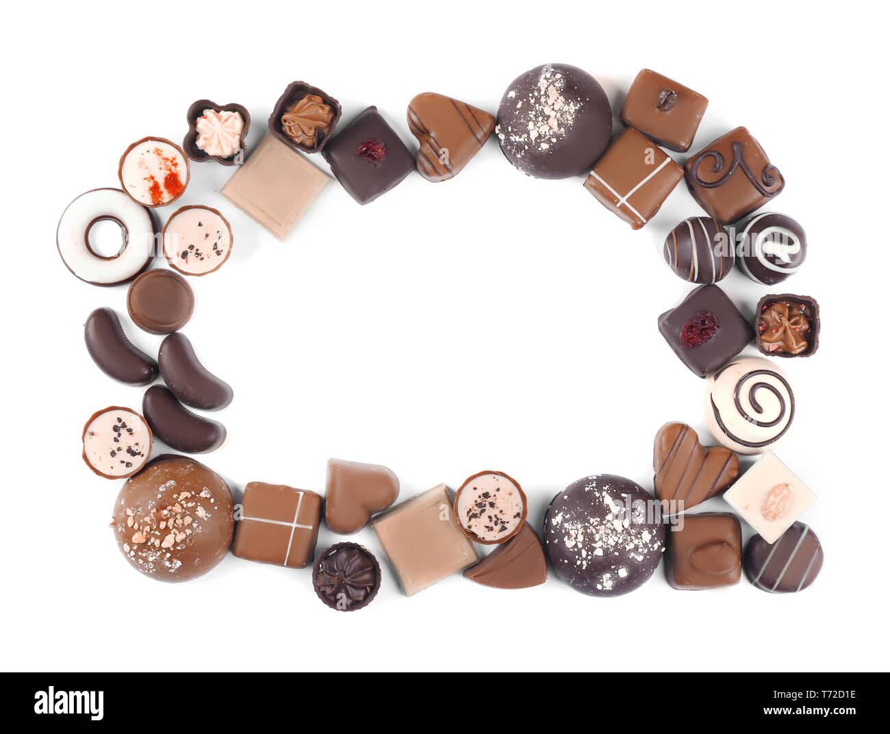 Frame made of different tasty chocolate candies on white background ...
