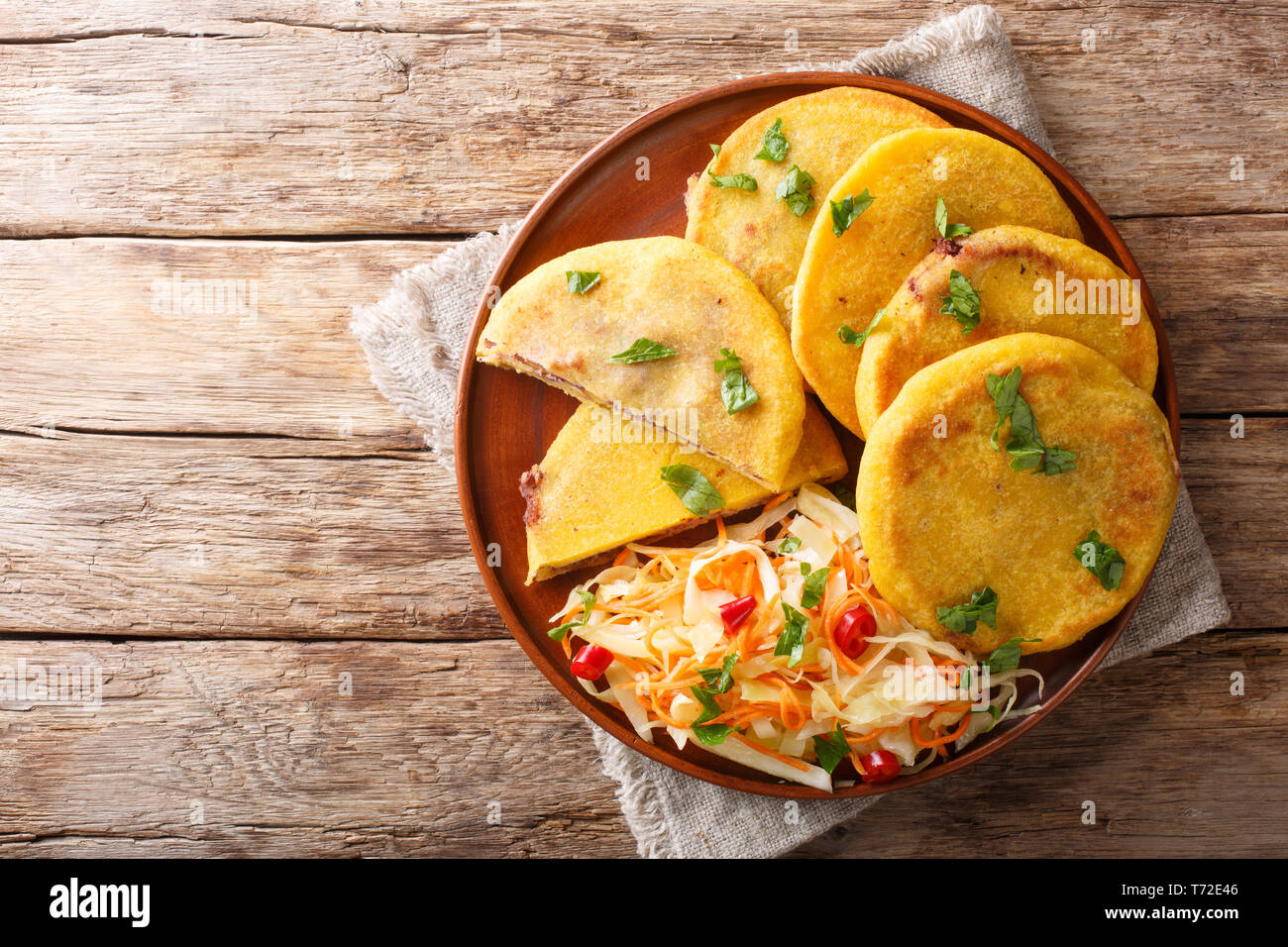 Salvadoran pupusa served with curtido closeup on a plate. horizontal top view from above Stock Photo