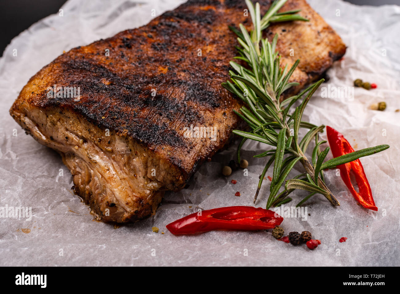 Roasted pork loin with herbs on black background. Macro Stock Photo Alamy