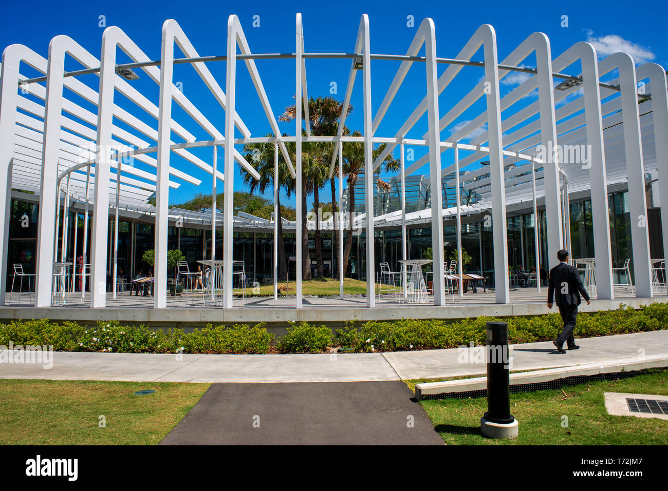 The Calyx building at the Royal Botanic Gardens with people relaxing in the gardens in Sydney, Australia Stock Photo